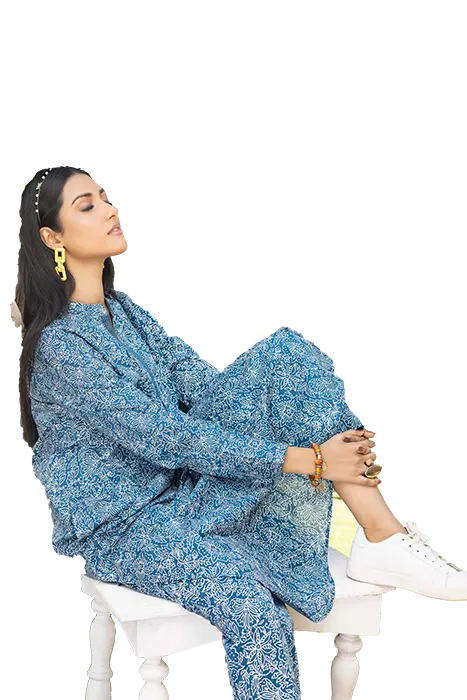 A Women Sitting in Blue printed pakistani suit by Gul Ahmed