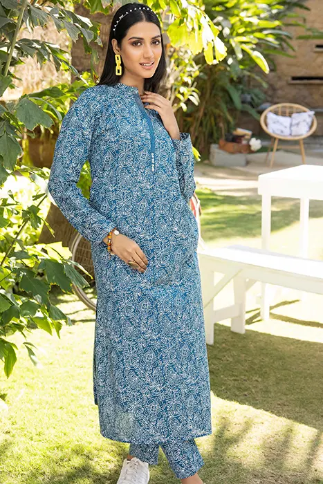 A Women Standing in Blue printed pakistani suit by Gul Ahmed