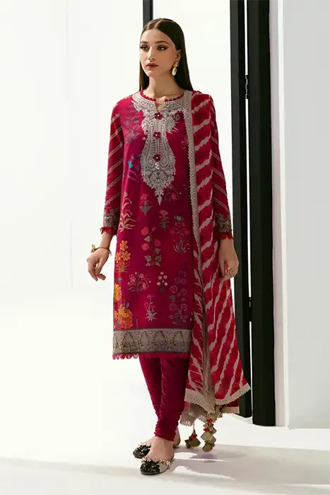 A women standing in Pink Pakistani suit by Sana safinaz