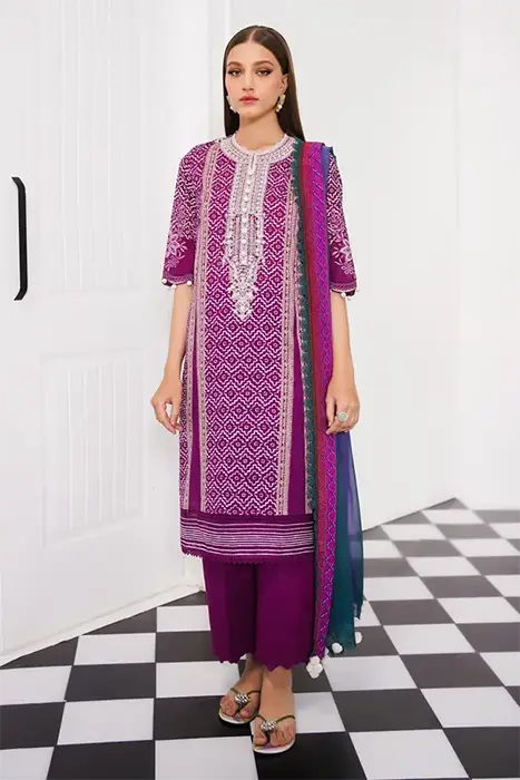 A Women standing in printed Pink Pakistani Suit