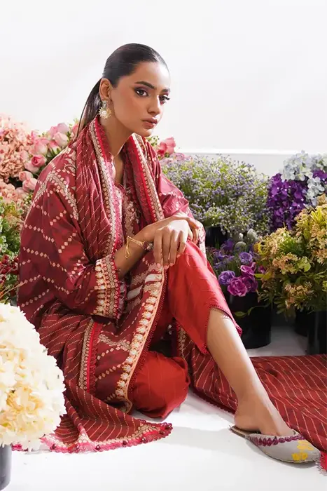 A women sitting in red colour pakistani suit