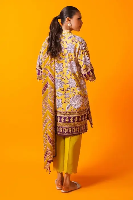 A yellow printed pakistani suits by Sana Saifinaz
